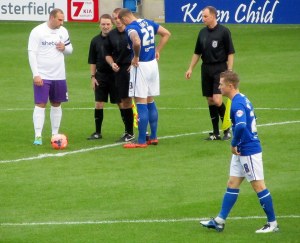 The two captains, Liam Dolman and Ian Evatt, speak to the referee